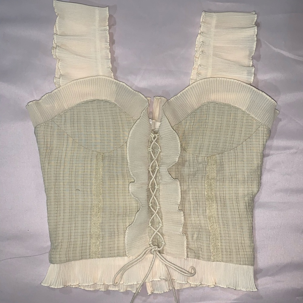 Ruffle blouse with lace up detail